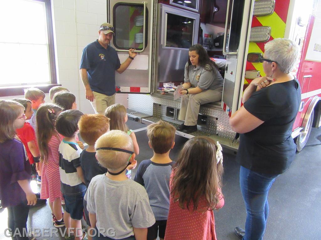 Fire Prevention Chairman Bridget Weishaar and Lt. Patrick Livesay show some different types of EMS equipment to a small group of four year olds.