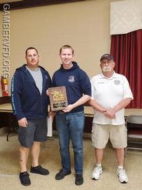 Sean Baldwin accepts the Gerald L. Lindsay Memorial Firefighter of the Year Award from 1st Vice President/Captain Chad Hastings (L) and President Dale Bollinger. 