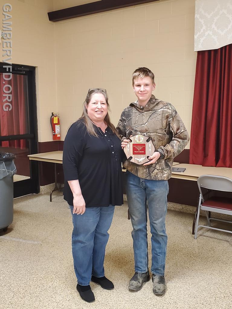 Wyatt Frederick accepts the Junior Firefighter of the Year Award from 2nd Vice-President Chrissy Green.