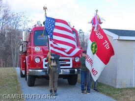Boy Scout Troop 719 presented the colors at the ceremony with Gamber Engine 132 in the background.