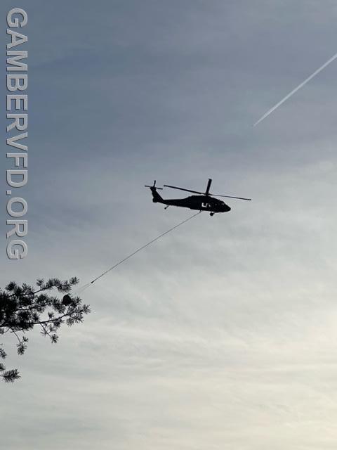 A Maryland National Guard Blackhawk helicopter prepares to do a water drop on the wild fire.