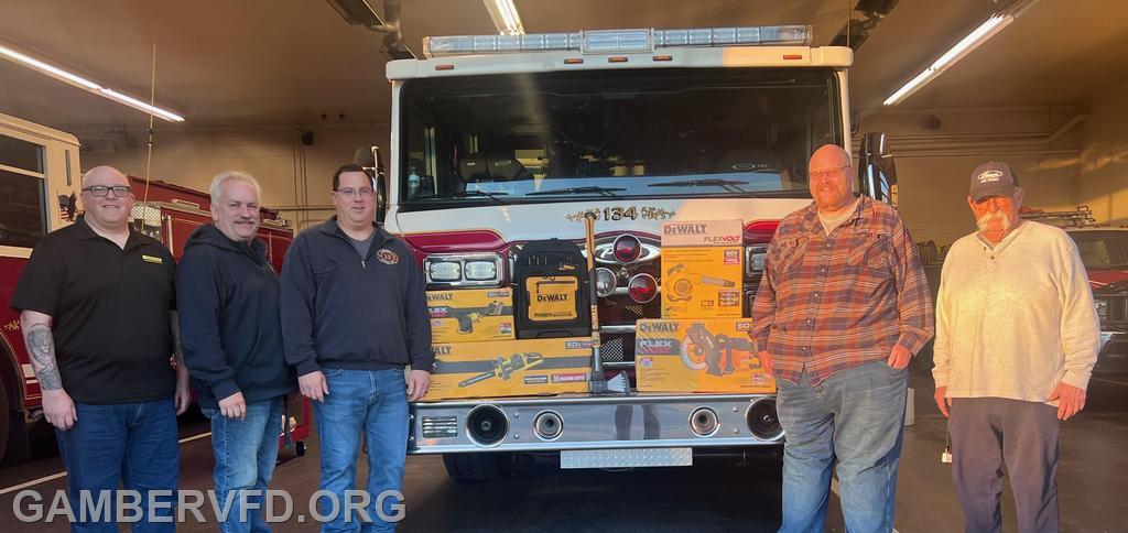 Pictured l to r, John Bartels, Assistant Chief Shawn Chenoweth, Chief Chad Hastings,  Assistant Chief Charlie Green, and President Dale Bollinger. Some of the donated items are displayed on the front of Engine 134.