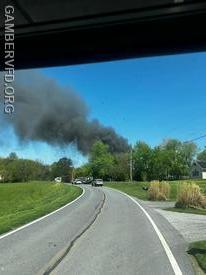 Responding units reported a large column of black smoke several miles before arrival indicating a working fire.
