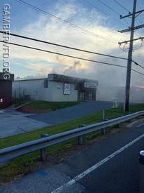 Smoke rolling from the building early in the incident.